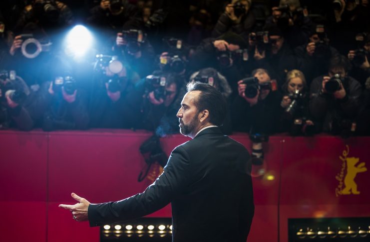 Nicolas Cage, voice of character Grug, poses on red carpet before screening of movie “The Croods” at Berlinale International Film Festival in Berlin