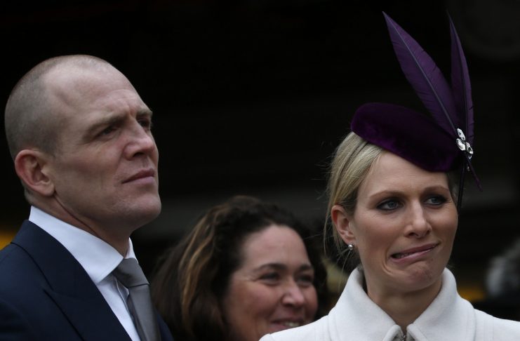 Britain’s Phillips reacts while talking to McCoy as her husband Tindall stands by her in the unsaddling enclosure at the Cheltenham Festival horse racing meet in Gloucestershire