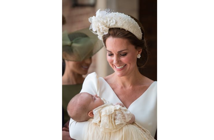 Britain’s Catherine, the Duchess of Cambridge, carries Prince Louis as they arrive for his christening service at the Chapel Royal, St James’s Palace, London