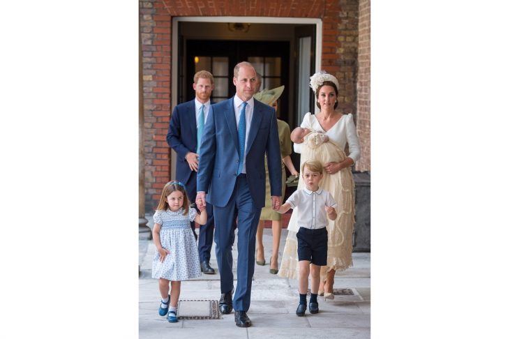 Britain’s Princess Charlotte and Prince George hold the hands of their father, the Duke of Cambridge, as they arrive for the christening of their brother, Prince Louis, who is being carried by the Duchess of Cambridge, at the Chapel Royal