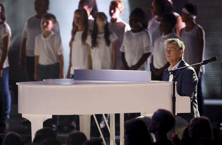 Musician David Foster performs on a piano during WE Day California in Inglewood