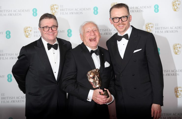 Mel Brooks holds his Fellowship award with presenters Simon Pegg and Nathan Lane at the British Academy of Film and Television Awards (BAFTA) in London