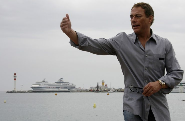 Actor Jean-Claude Van Damme gestures at a photocall on the beach front in Cannes