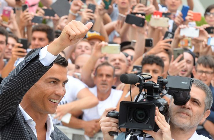 Cristiano Ronaldo gestures as he arrives at the Juventus’ medical center in Turin