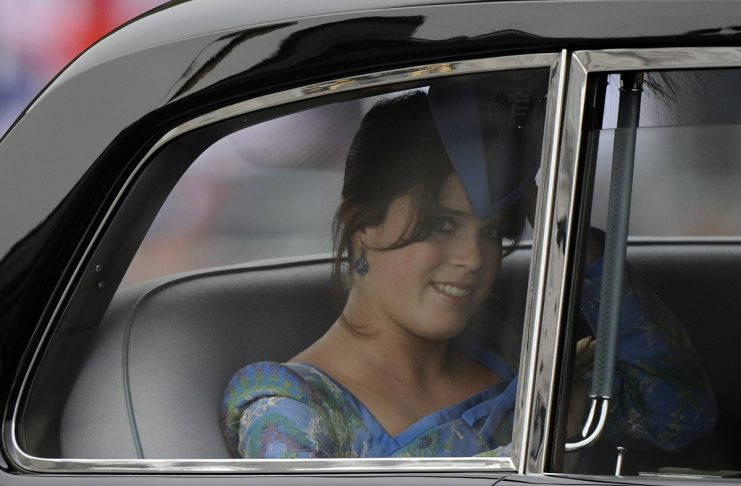 Britain’s Princess Eugenie looks out from a car on her way to the the wedding of Britain’s Prince William and Kate Middleton in central London