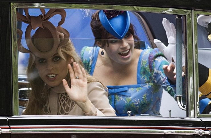 Britain’s Prince Andrew and his daughters Princess Beatrice and Princess Eugenie travel along the Procession Route, after the wedding of Britain’s Prince William and Catherine, Duchess of Cambridge in Westminster Abbey, in central London