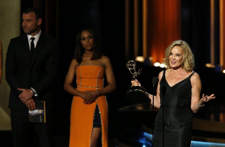 Lange accepts the award for Outstanding Lead Actress In A Miniseries Or A Movie for her role in “American Horror Story: Coven” as presenters Washington and Schreiber look on during the 66th Primetime Emmy Awards in Los Angeles