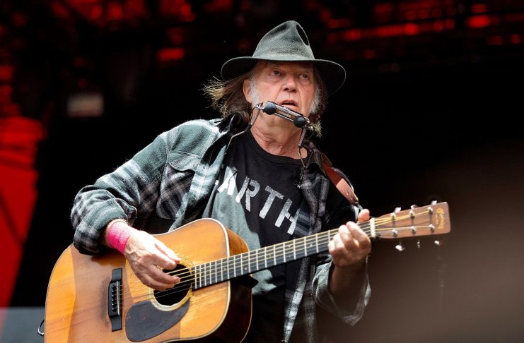 Canadian singer-songwriter Neil Young performs at the Orange Stage at the Roskilde Festival