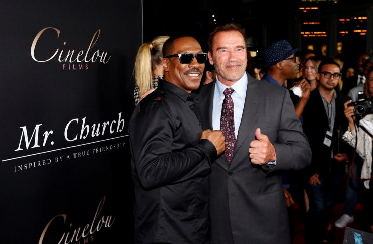 Cast member Murphy poses with former California Governor Schwarzenegger at the premiere of “Mr. Church” in Los Angeles