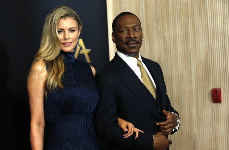 Actor Eddie Murphy and companion Paige Butcher arrive at the Hollywood Film Awards in Beverly Hills