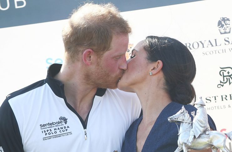 Britain’s Prince Harry kisses his wife Meghan the Duchess of Sussex after a charity polo match in Windsor