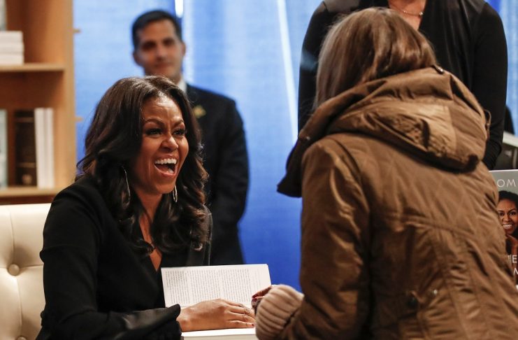 Former first lady Michelle Obama signs copies of her memoir Becoming in Chicago
