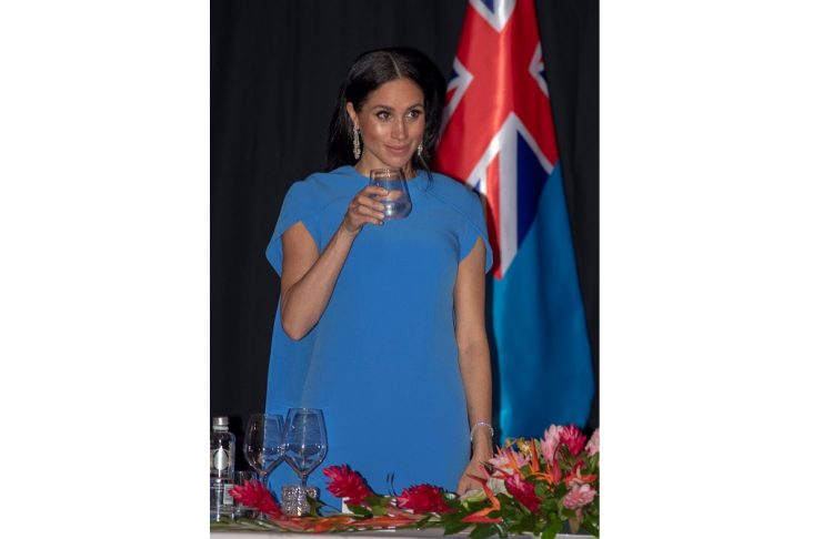 Britain’s Meghan, the Duchess of Sussex, raises her glass as she attends a state dinner at Grand Pacific Hotel in Suva
