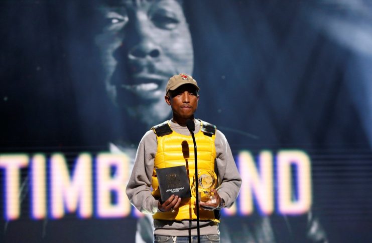Recording artist Williams stands on stage to present record producer Timbaland with the Lifetime Achievement Award at the 6th annual REVOLT Global Spin Awards in Los Angeles