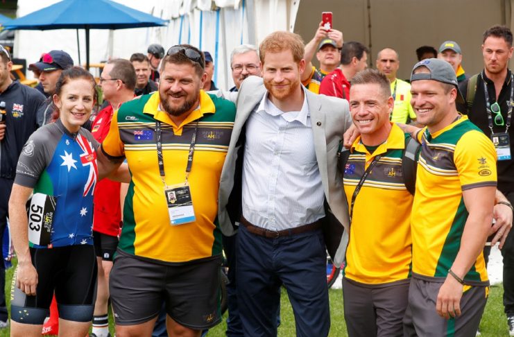Britain’s Prince Harry poses with athletes during the Invictus Games at the Royal Botanic Garden in Sydney