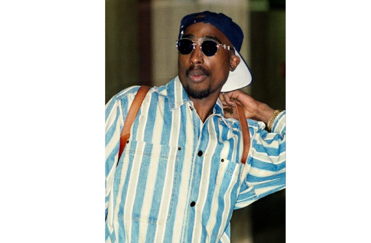 Rap singer and actor Tupac Shakur is shown as he arrives for a court hearing on weapon possession ch..