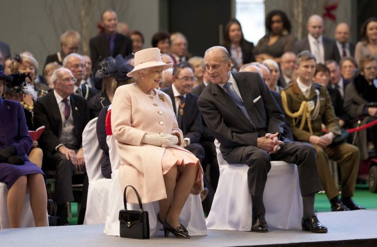 Britain’s Queen Elizabeth and her husband Prince Philip watch performers during a visit to the Manchester Central Convention Centre in Manchester