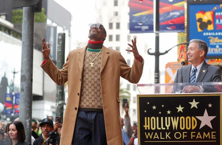 Rapper Snoop Dogg reacts as he is introduced to the crowd during a ceremony for his star on the “Hollywood Walk of Fame” in Los Angeles