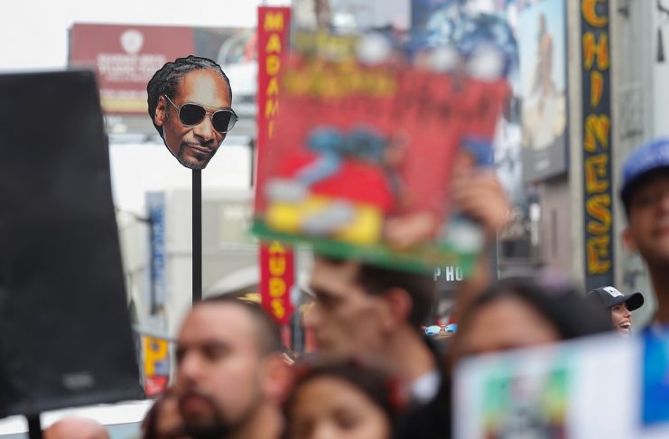 A fan holds up a sign of rapper Snoop Dogg’s face as he receives his star on the “Hollywood Walk of Fame” in Los Angeles