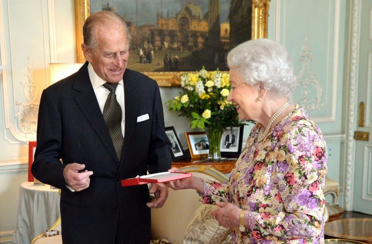 Britain’s Queen Elizabeth presents her husband Prince Philip with New Zealand’s highest honour, the Order of New Zealand at Buckingham Palace in London