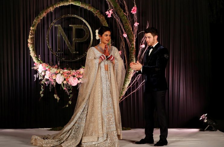 Bollywood actress Priyanka Chopra and her husband singer Nick Jonas pose during a photo opportunity at their wedding reception in New Delhi