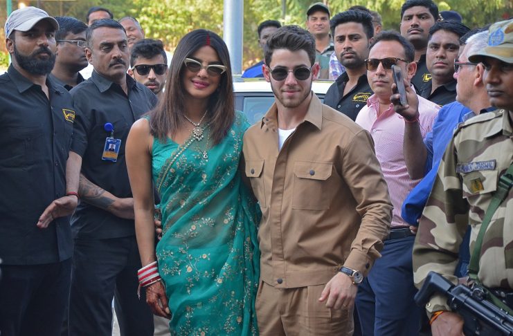 Bollywood actress Priyanka Chopra and her husband singer Nick Jonas pose outside the airport in Jodhpur
