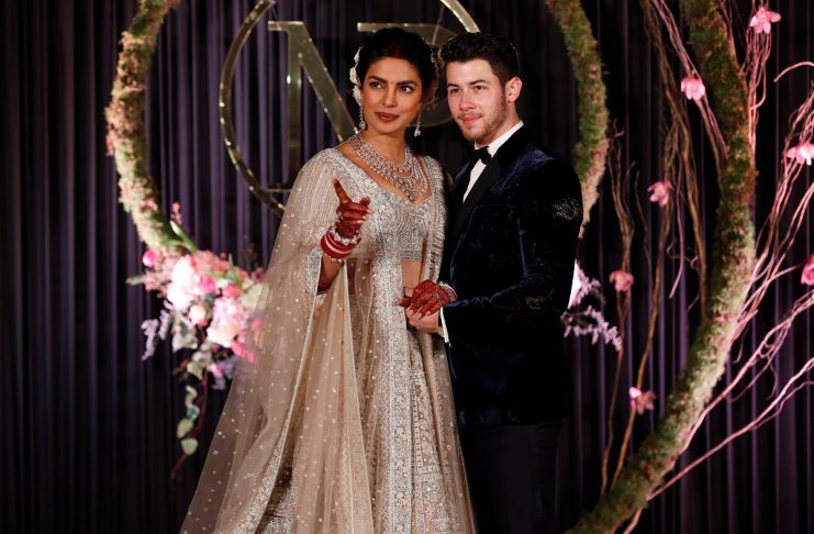 Bollywood actress Priyanka Chopra and her husband singer Nick Jonas pose during a photo opportunity at their wedding reception in New Delhi