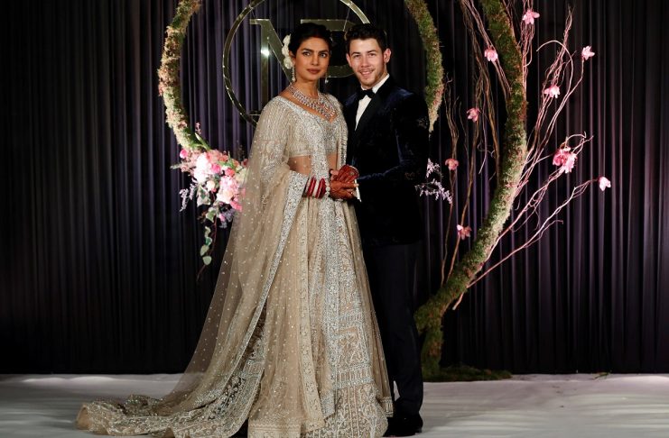 Bollywood actress Priyanka Chopra and her husband singer Nick Jonas arrive for a photo opportunity at their wedding reception in New Delhi