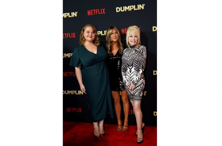 Cast members Danielle MacDonald, Jennifer Aniston and Dolly Parton pose at a premiere for the movie Dumplin’ in Los Angeles, California