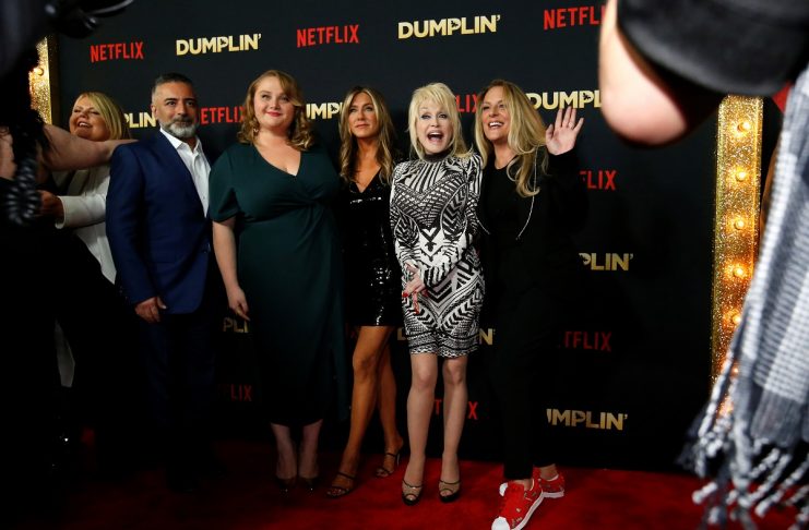 Dolly Parton and others pose at a premiere for the movie Dumplin’ in Los Angeles, California