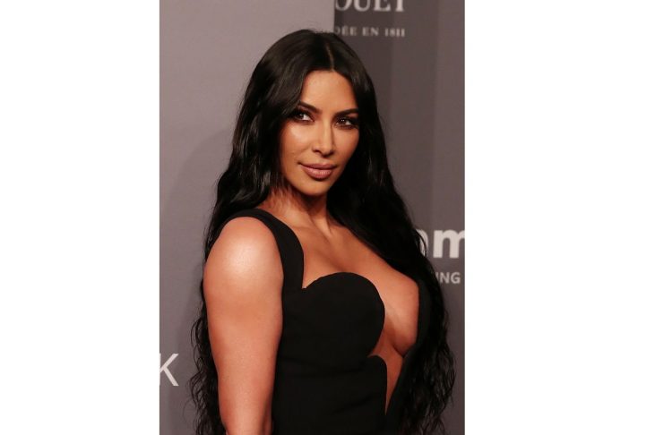 Kim Kardashian poses on the red carpet for the amfAR gala in New York