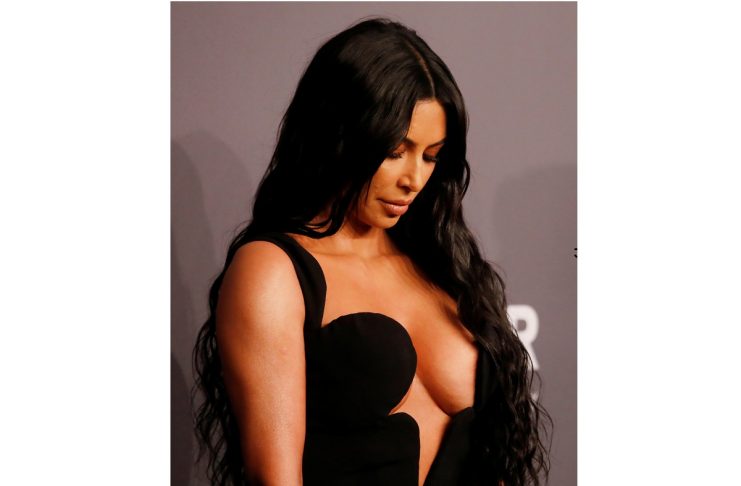 Kim Kardashian looks down on the red carpet for the amfAR gala in New York