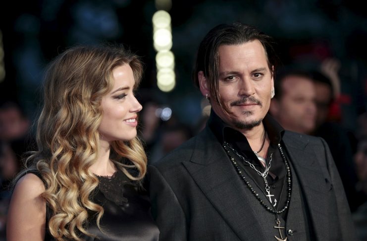 Cast member Johnny Depp and his actress wife Amber Heard arrive for the British premiere of the film “Black Mass” in London