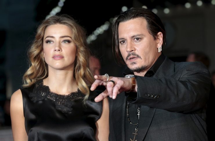 File photo of cast member Johnny Depp and his actress wife Amber Heard arrive for the premiere of the British film “Black Mass” in London