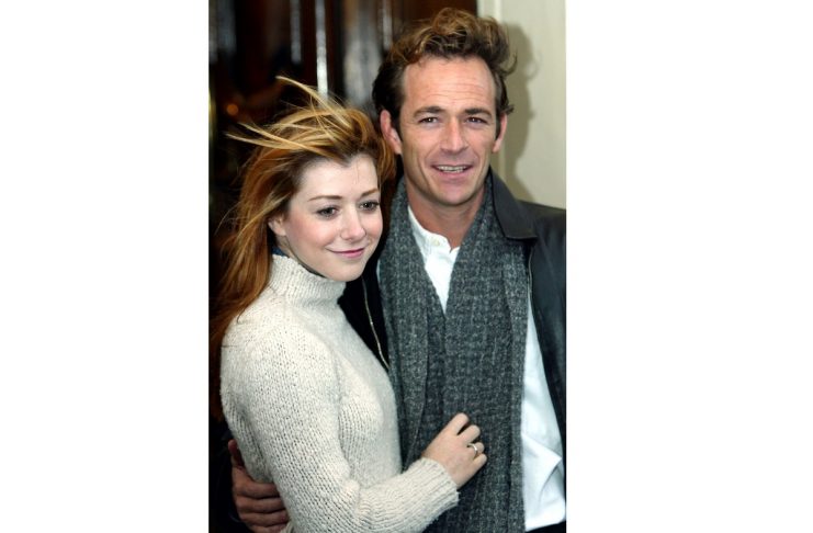 U.S. actor Luke Perry (R) and actress Alyson Hannigan pose for photographers outside the Theatre Roy..