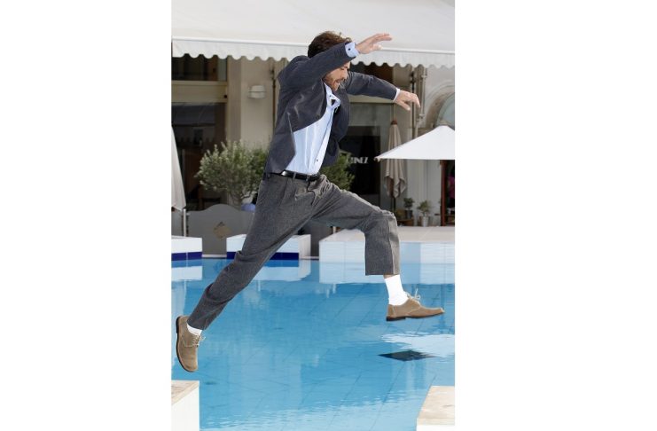 U.S. actor Luke Perry jumps over a swimming pool during a photocall to promote his television series “Goodnight For Justice” at the annual MIPCOM television programme market in Cannes