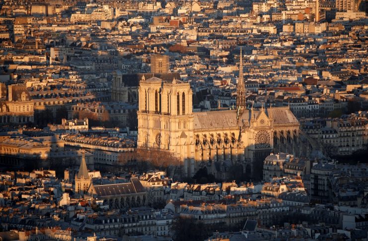 A general view shows the Notre Dame Cathedral and rooftops at sunset in Paris