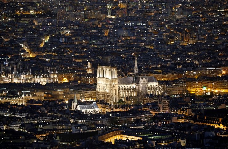 A general view shows the Notre Dame Cathedral and rooftops at night in Paris