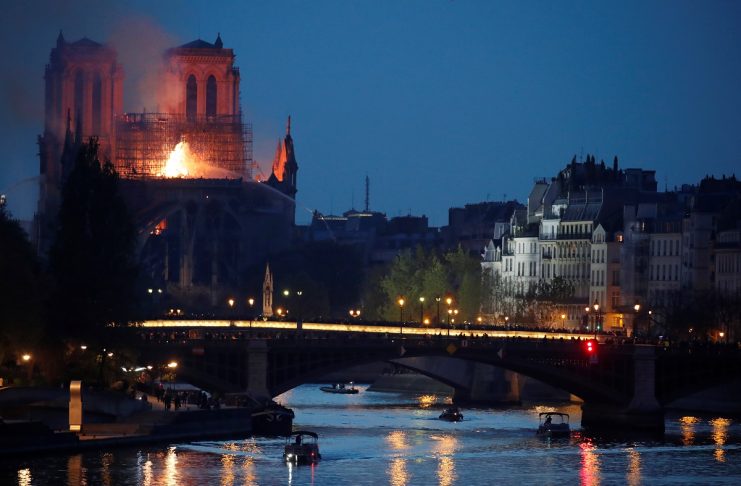 Smoke rises from the burning roof at the Notre-Dame Cathedral after a fire broke out, in Paris,